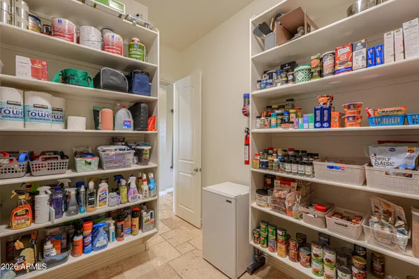 a view of walk in closet with clothes