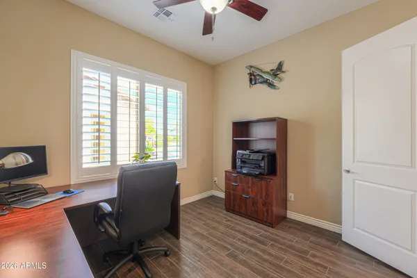 a bathroom with a granite countertop sink a toilet and shower