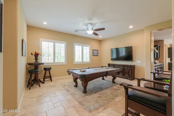 a view of a house with a yard and a large tree