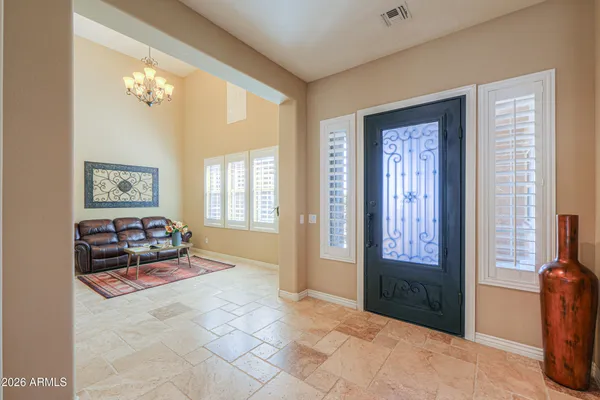 a living room with furniture a table and a large window
