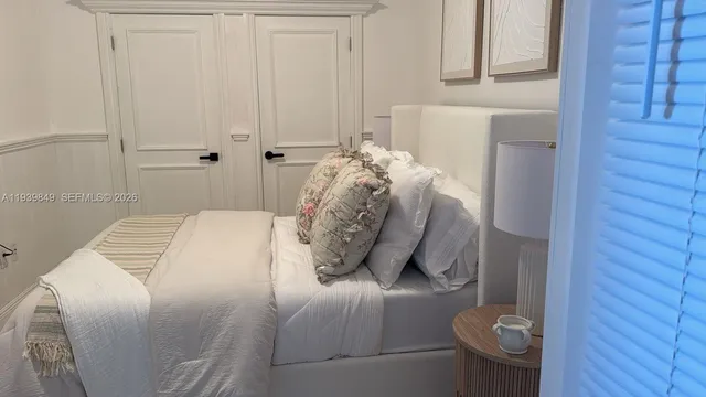 a bedroom with a bed and mirror