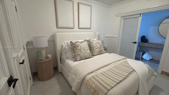 a bedroom with a bed and a night stand