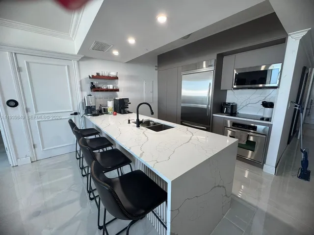 a living room with furniture fireplace and a large window