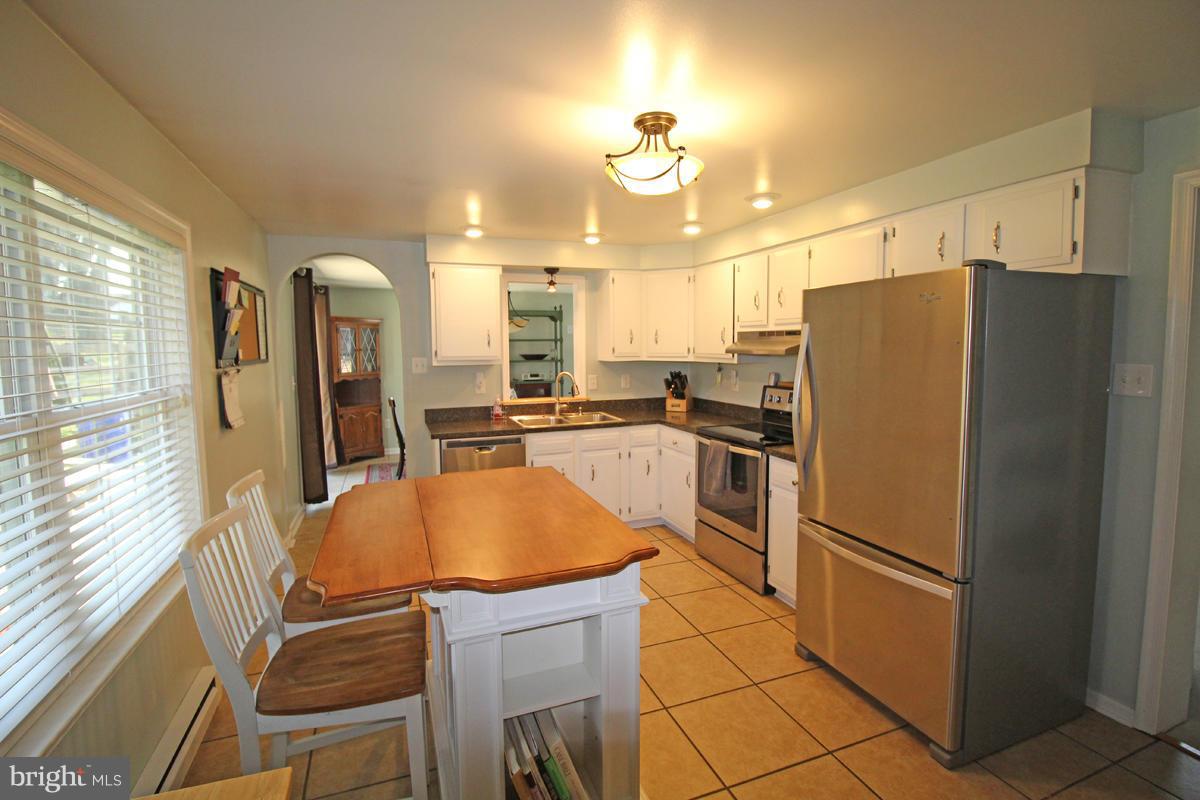 6603 South Clifton Road Frederick, MD 21703 - Photo 13 of 21 a kitchen with stainless steel appliances a refrigerator and microwave