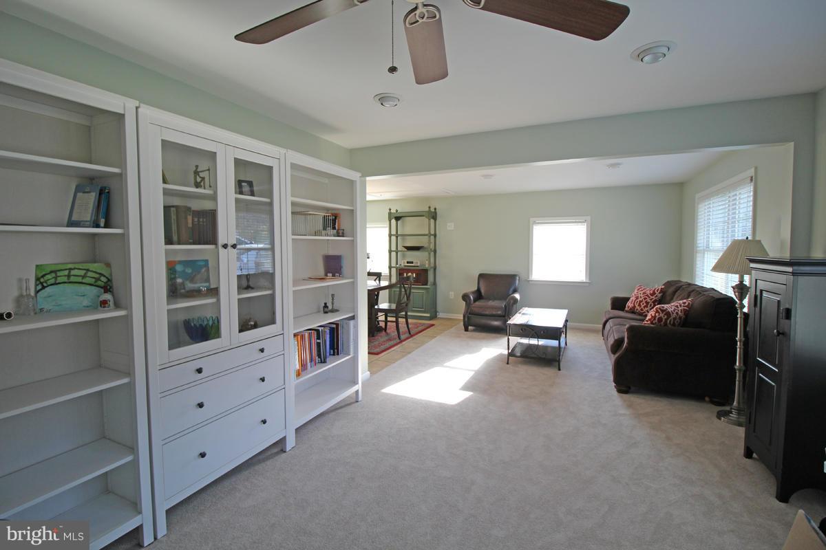 6603 South Clifton Road Frederick, MD 21703 - Photo 4 of 21 a living room with furniture and a book shelf
