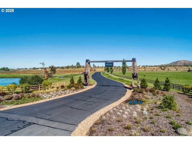a view of a patio with a table and chairs under an umbrella
