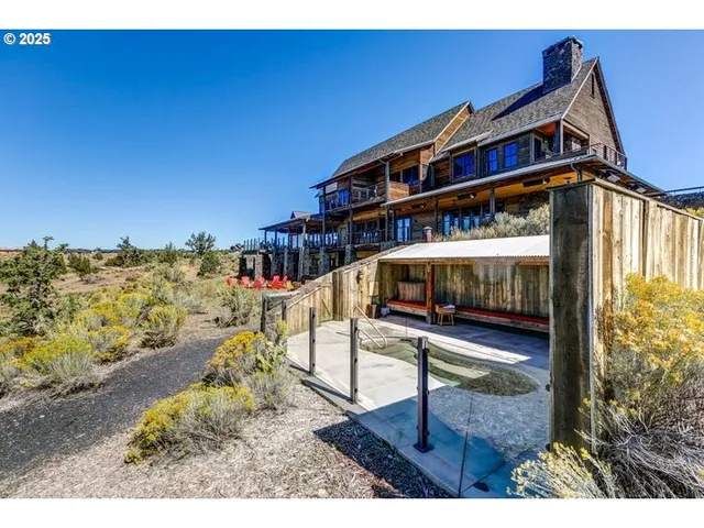 a view of a patio with a table and chairs under an umbrella