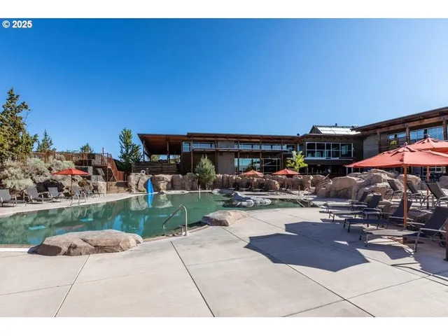 a view of swimming pool with outdoor seating and plants