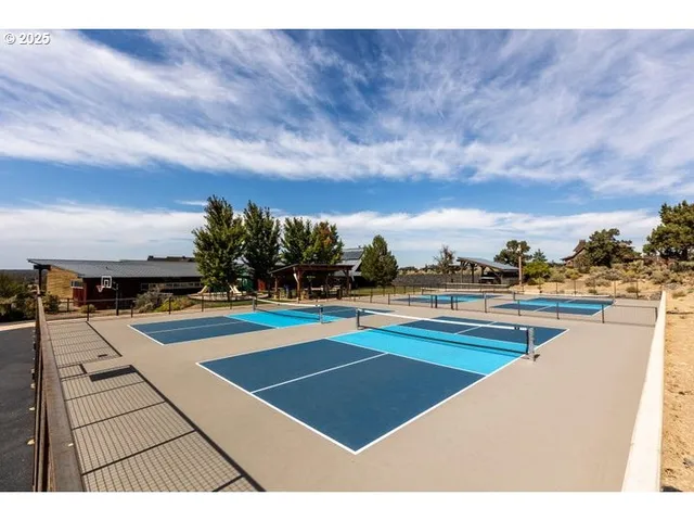 a view of tennis court with houses