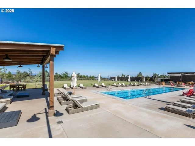 a view of an outdoor sitting area with furniture and umbrella