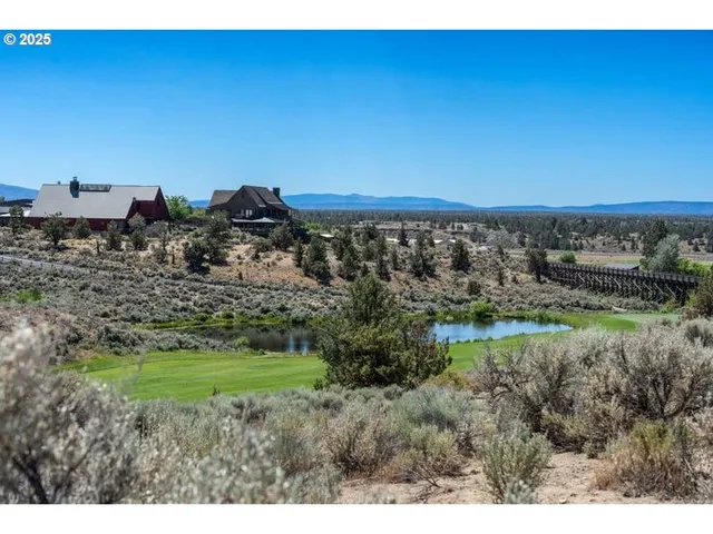 a view of a field with a building in background