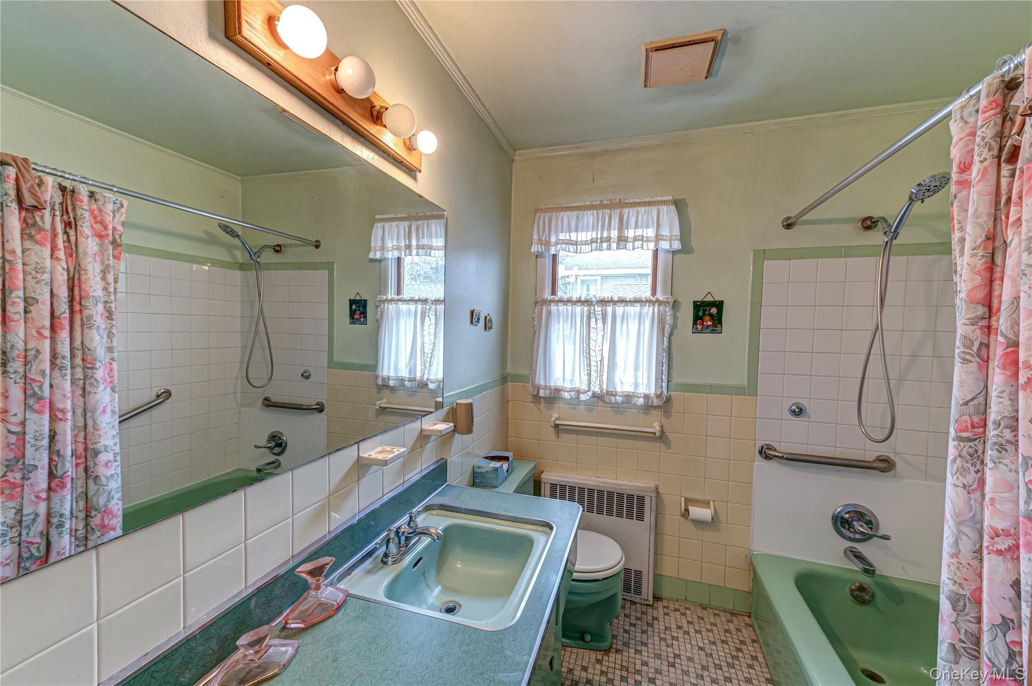 67 Edgewood Road West Islip, NY 11795 - Photo 15 of 31 a bathroom with a tub sink toilet and window