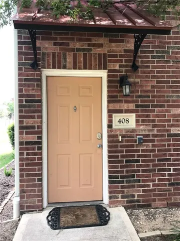 a living room with furniture a flat screen tv and kitchen view