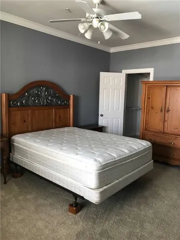 a white toilet sitting next to a wooden cabinet