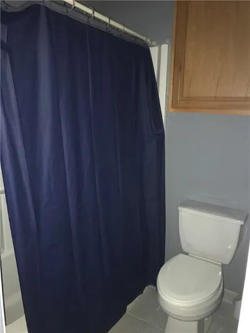 a bedroom with a bed and a mirror