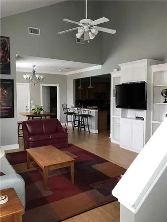 a living room with a flat screen tv and white walls