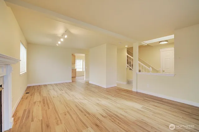 a view of an empty room and wooden floor