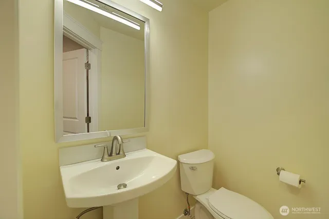 a white toilet sitting next to a bathroom sink