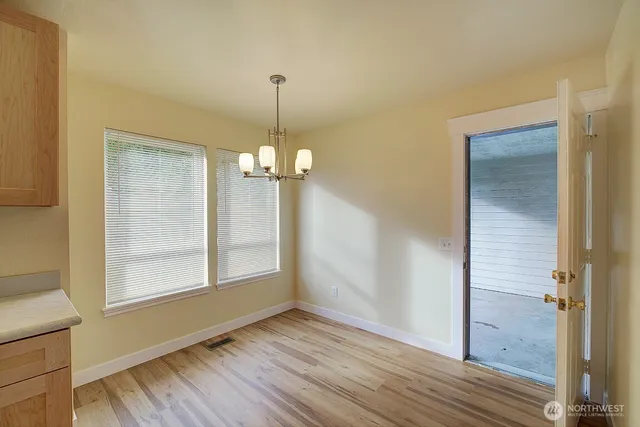 a view of a room with wooden floor staircase and a living room