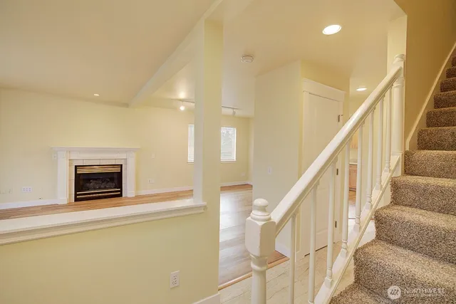 a view of entryway and hall with wooden floor