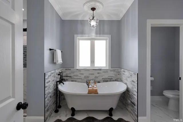 a bedroom with a bed and white cabinets