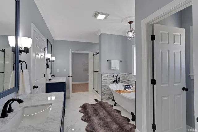 a spacious bedroom with two beds and a chandelier