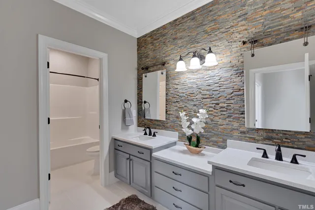 a bathroom with a toilet sink vanity and mirror