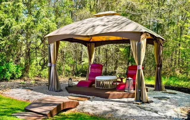 a dining room with furniture a chandelier and wooden floor