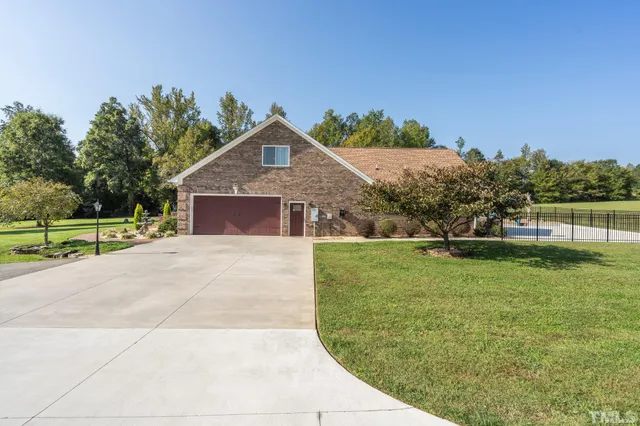 a large kitchen with stainless steel appliances and wooden cabinets