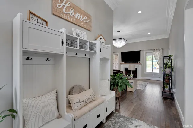 a kitchen with stainless steel appliances a stove a sink a microwave a dining table and chairs