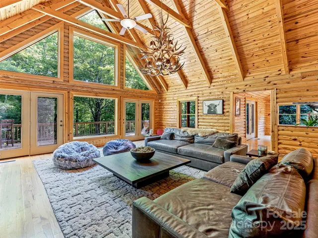 a living room with furniture and large windows