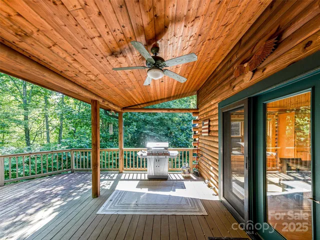 a view of a porch with wooden floor and roof