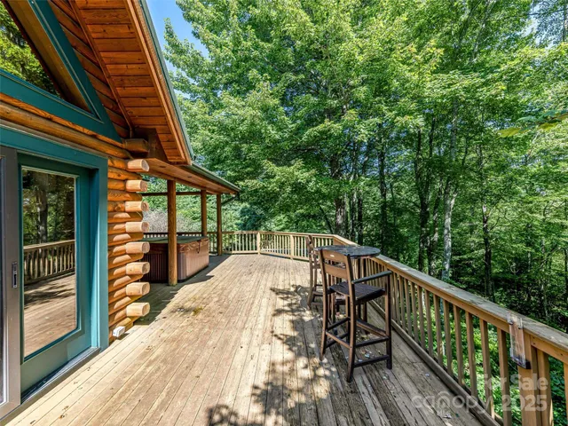 a view of balcony with wooden floor and fence