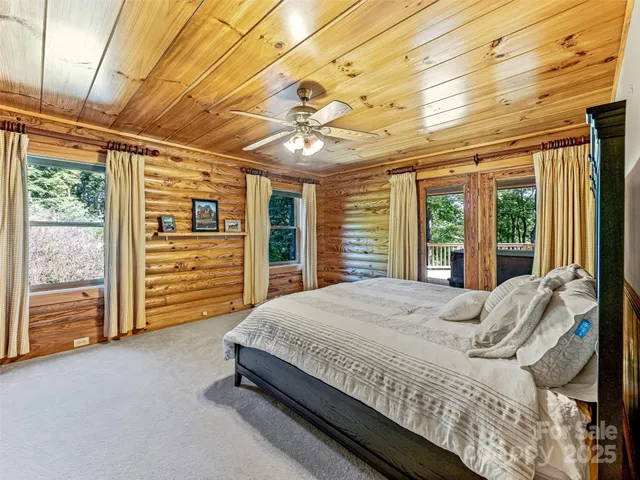 a bed sitting in a spacious bedroom next to a window