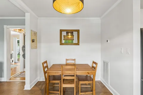 a view of a dining room with furniture and wooden floor