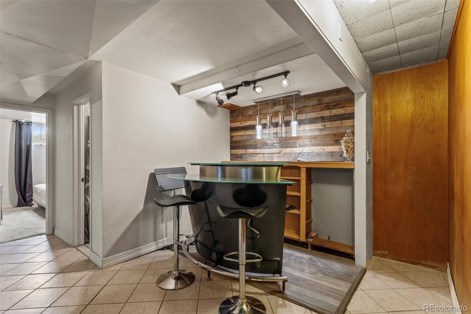 7296 Raritan Street Denver, CO 80221 - Photo 15 of 23 a view of a dining room with furniture and a chandelier