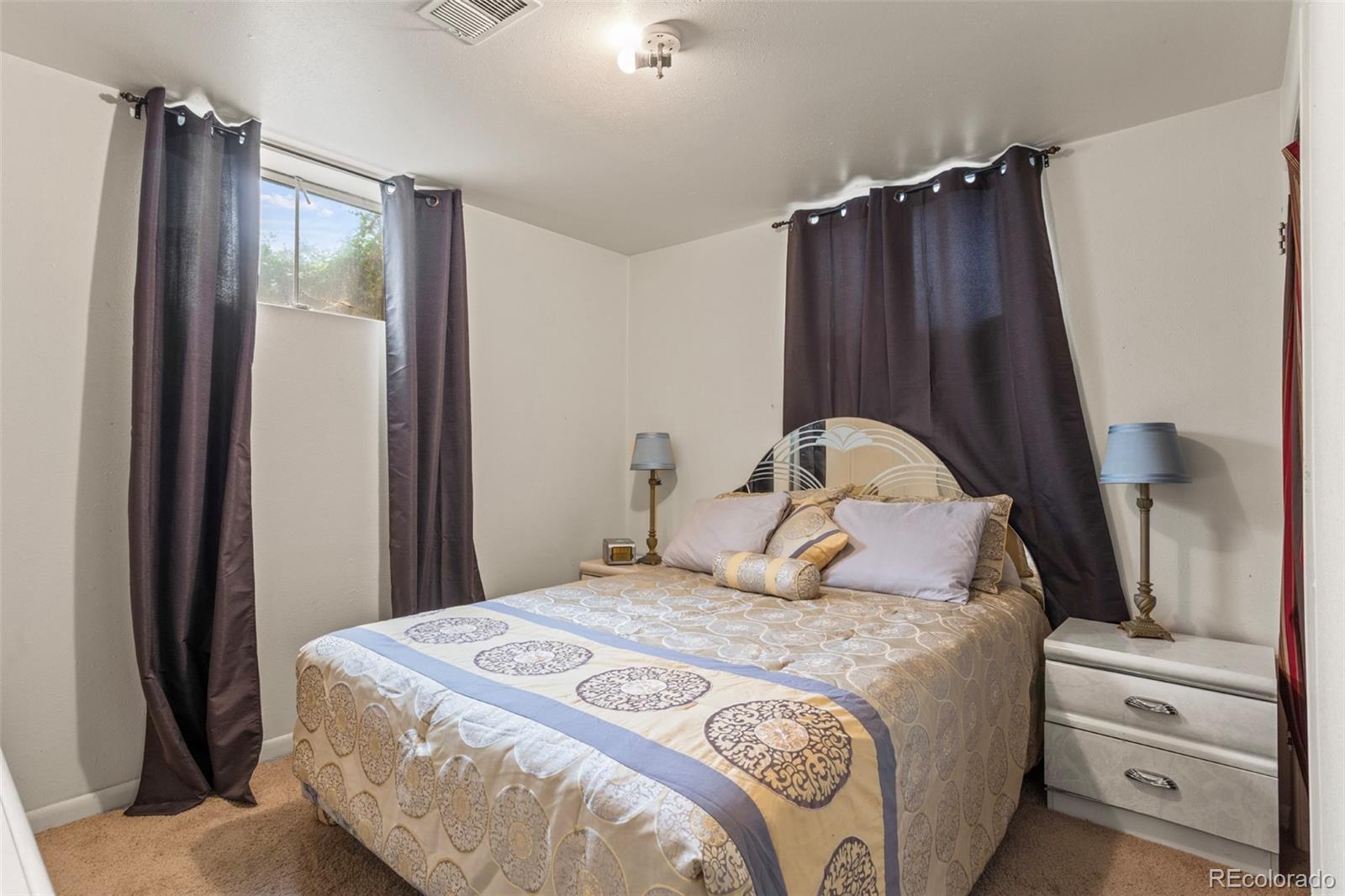 7296 Raritan Street Denver, CO 80221 - Photo 20 of 23 a bedroom with a bed and a dresser