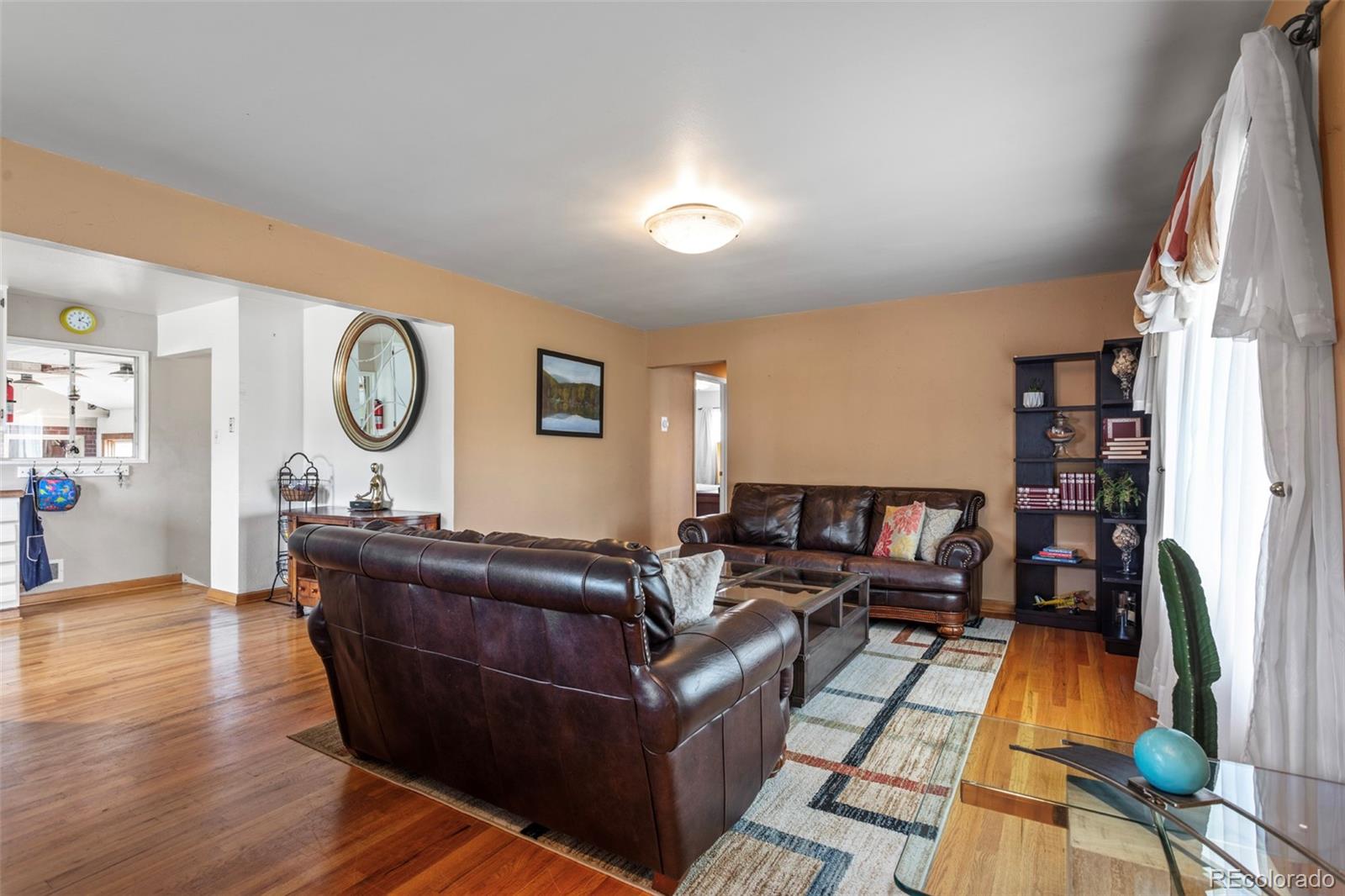 7296 Raritan Street Denver, CO 80221 - Photo 3 of 23 a living room with furniture and a clock