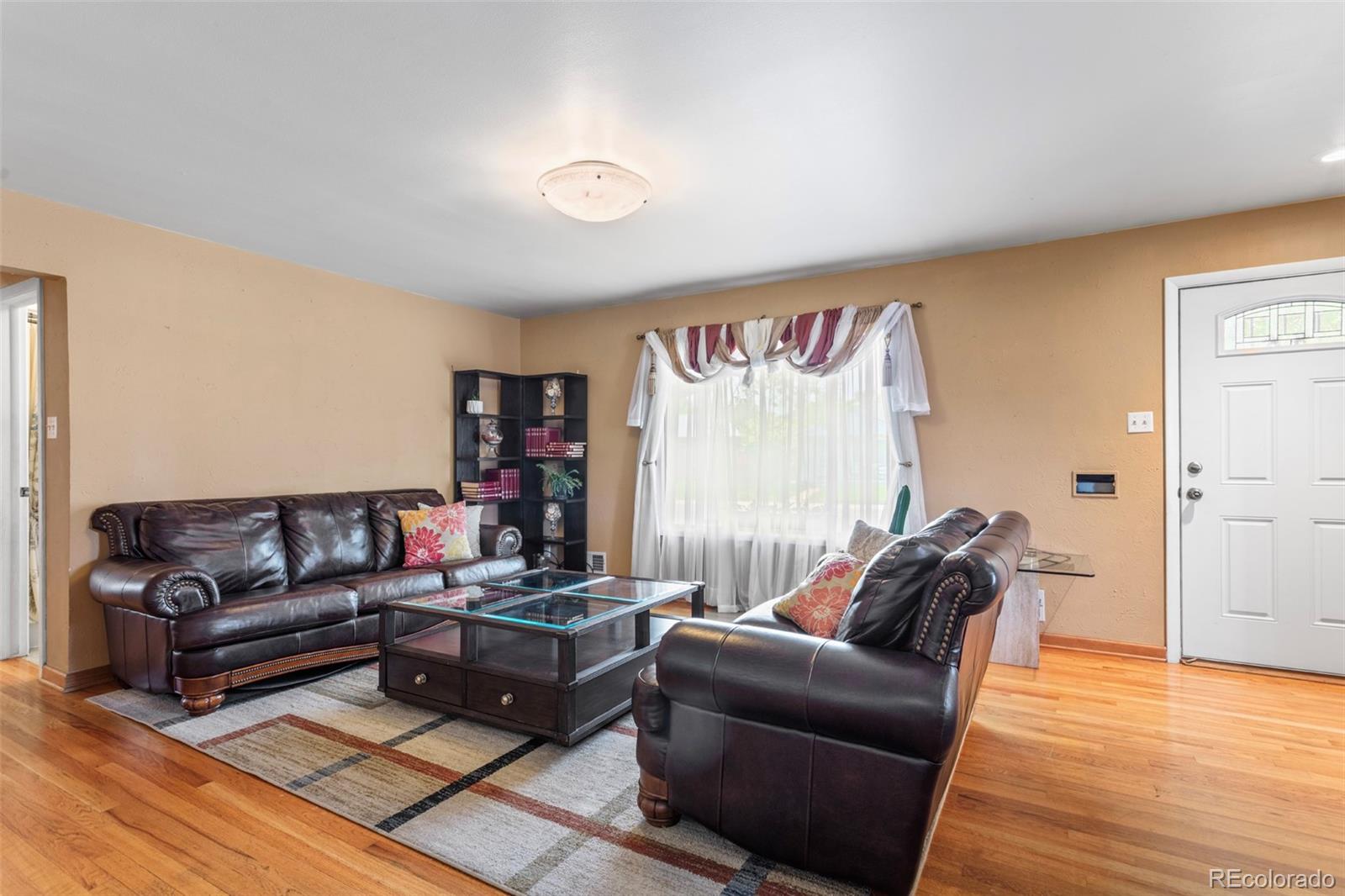 7296 Raritan Street Denver, CO 80221 - Photo 4 of 23 a living room with furniture and a wooden floor