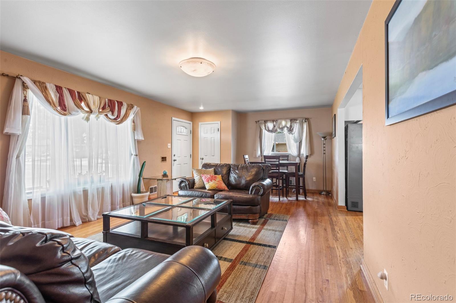 7296 Raritan Street Denver, CO 80221 - Photo 5 of 23 a living room with furniture and wooden floor