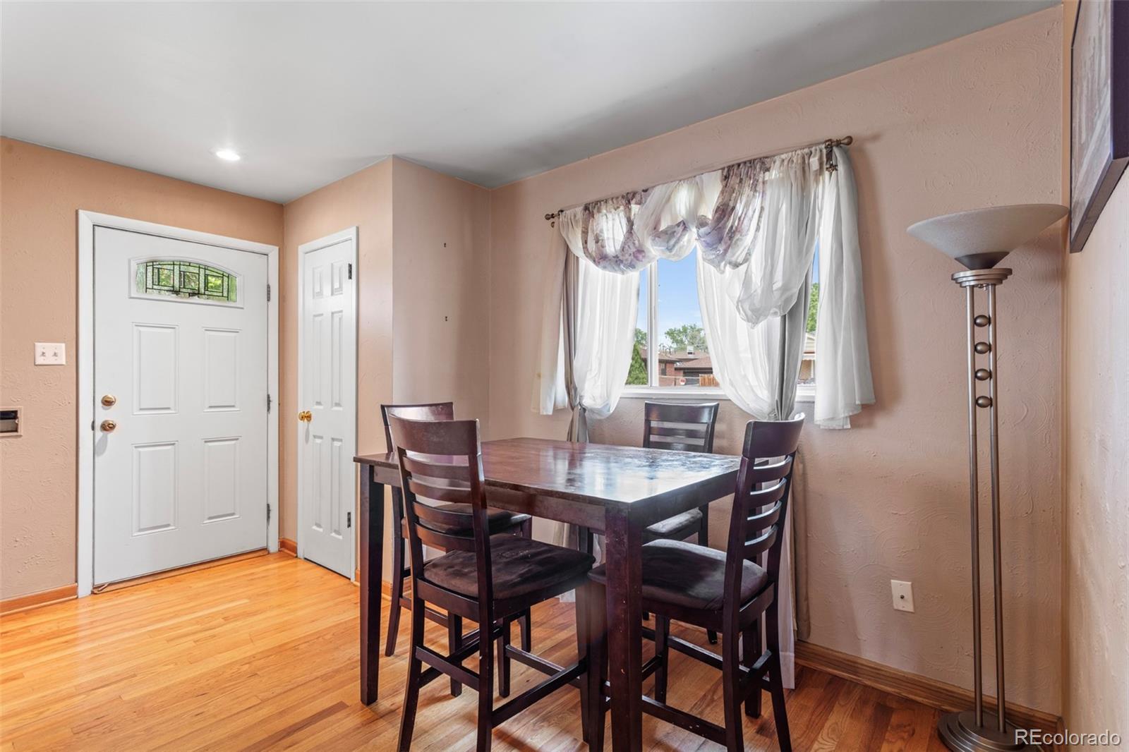 7296 Raritan Street Denver, CO 80221 - Photo 8 of 23 a view of a dining room with furniture window and wooden floor