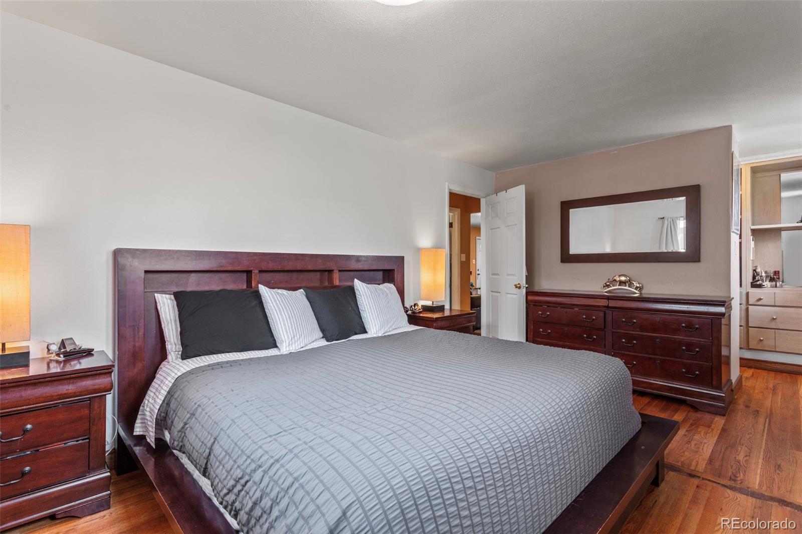 7296 Raritan Street Denver, CO 80221 - Photo 10 of 23 a bedroom with a bed and a dresser