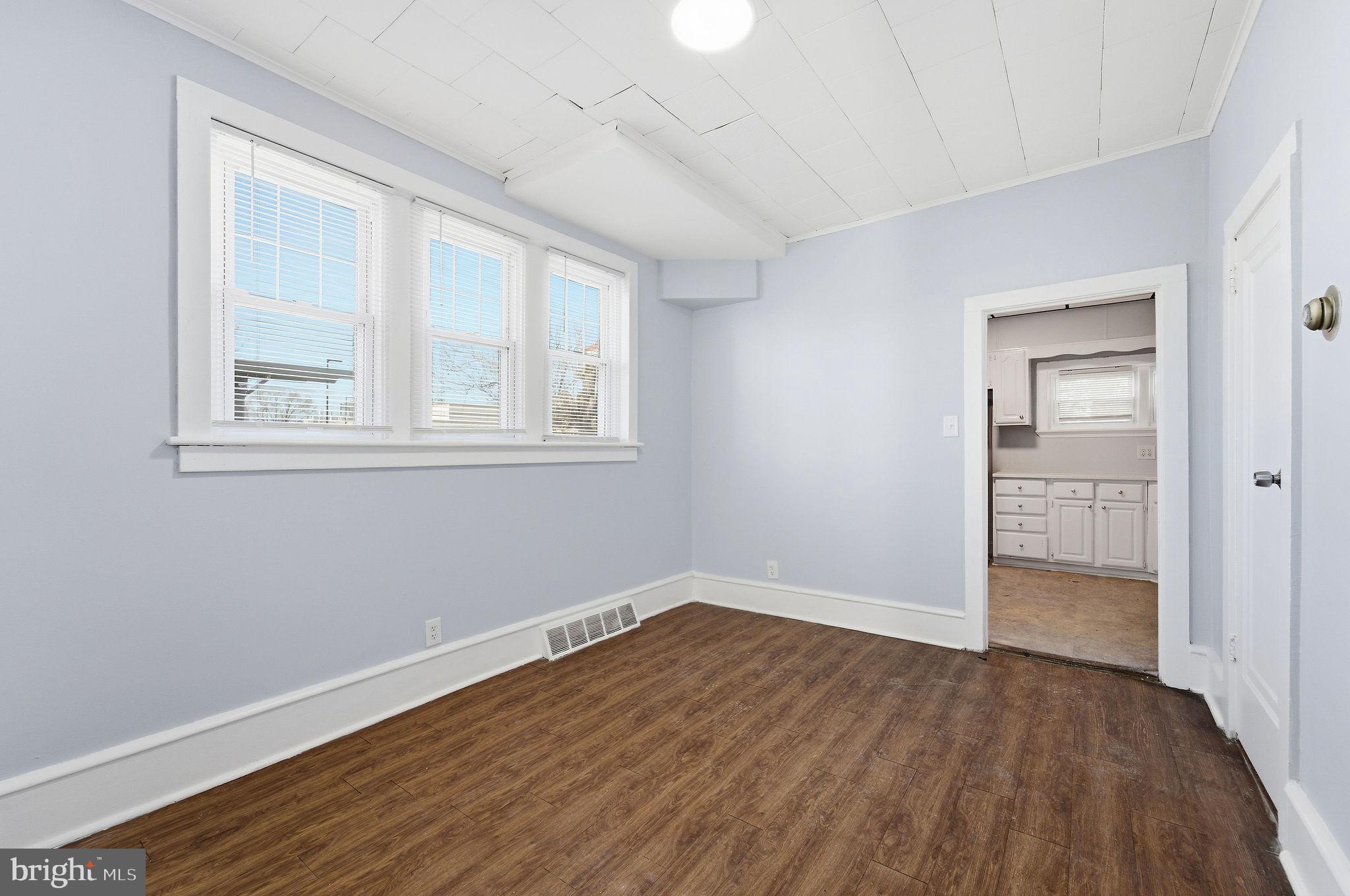 601 Hunter Street Gloucester City, NJ 08030 - Photo 12 of 35 an empty room with wooden floor and windows
