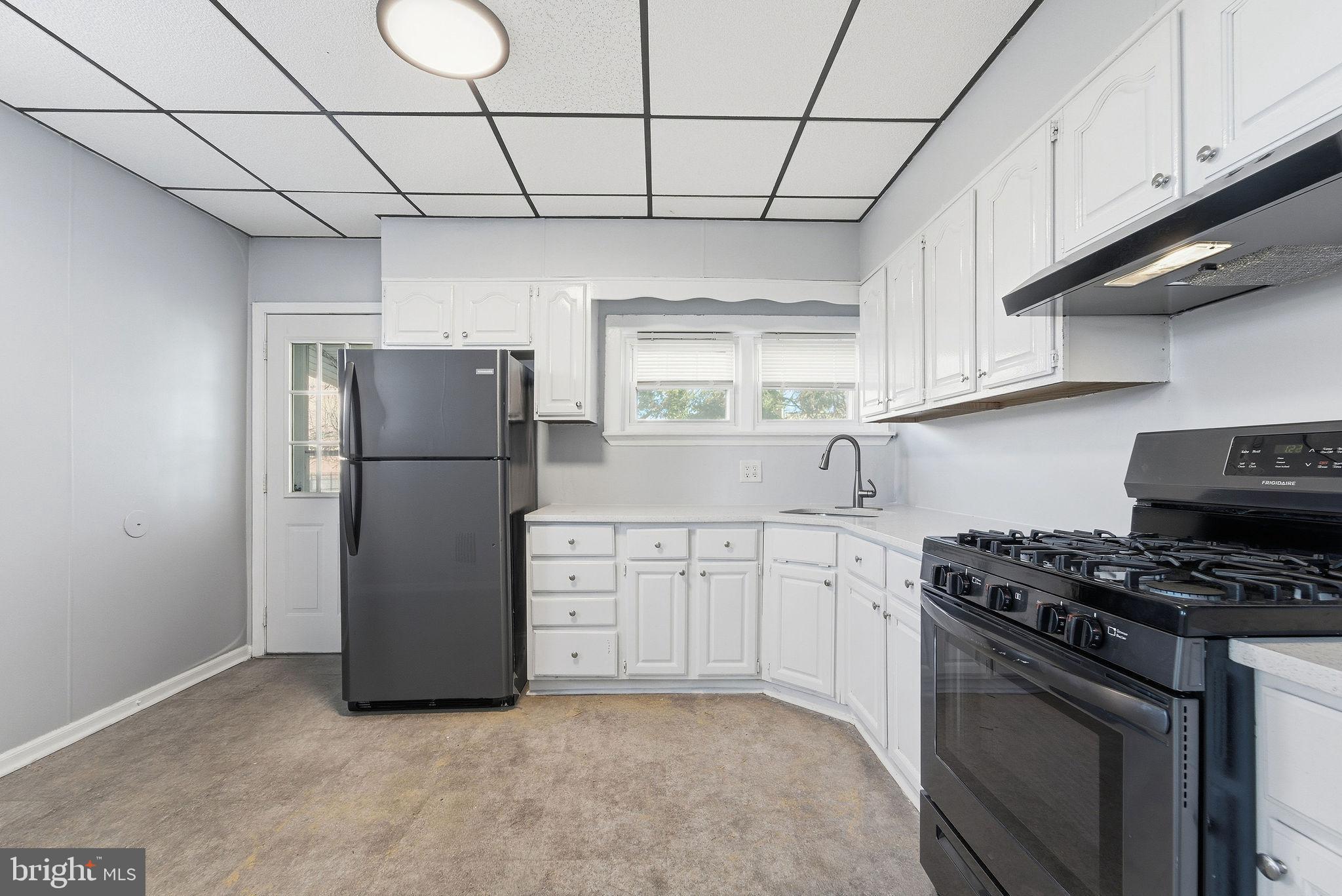 601 Hunter Street Gloucester City, NJ 08030 - Photo 15 of 35 a kitchen with stainless steel appliances a refrigerator sink and cabinets