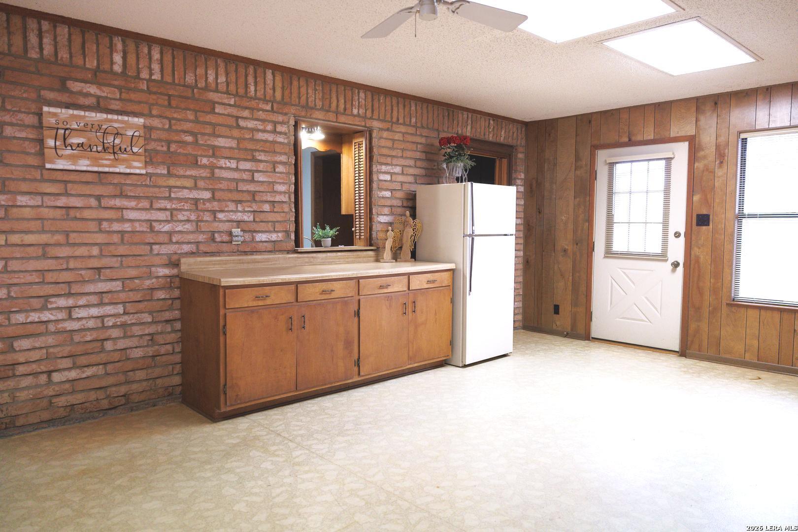 105 South Sayers Drive Devine, TX 78016 - Photo 11 of 23 a view of a kitchen with sink cabinet and natural light