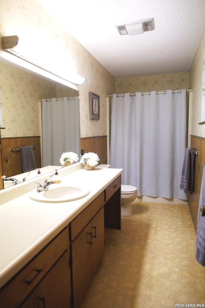 105 South Sayers Drive Devine, TX 78016 - Photo 16 of 23 a bathroom with a sink and a mirror