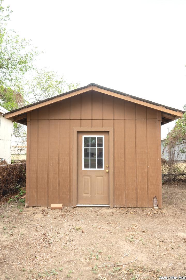 105 South Sayers Drive Devine, TX 78016 - Photo 21 of 23 an empty room with a wooden door