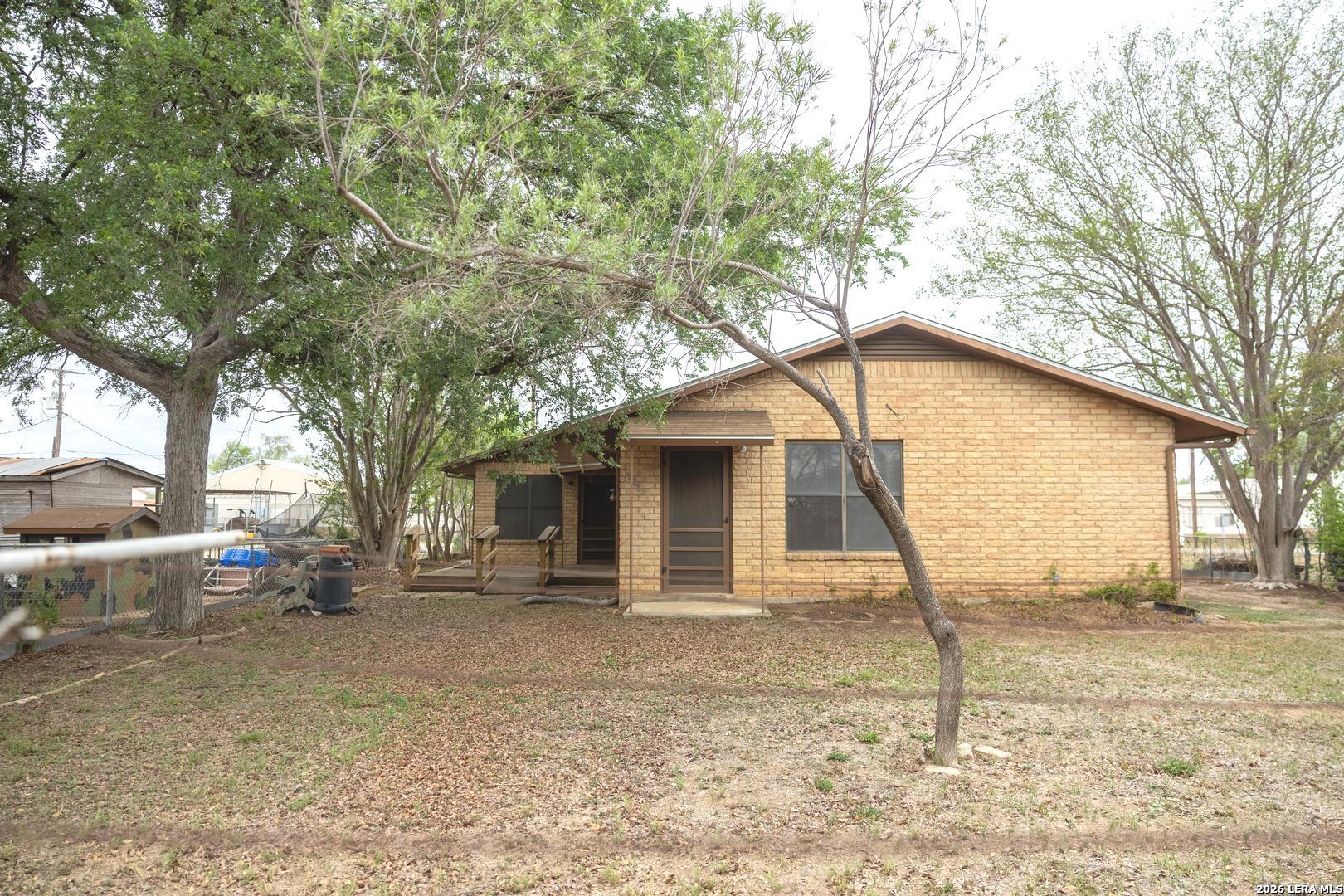 105 South Sayers Drive Devine, TX 78016 - Photo 23 of 23 a backyard of a house with table and chairs