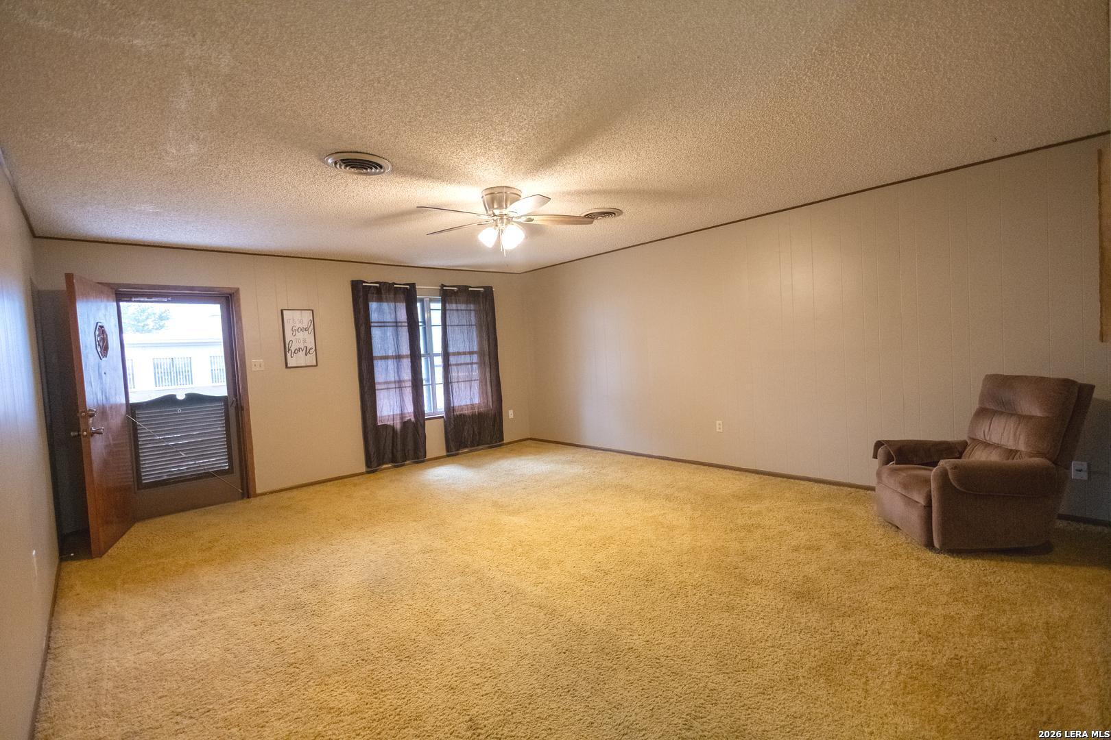 105 South Sayers Drive Devine, TX 78016 - Photo 4 of 23 a view of an empty room with a window