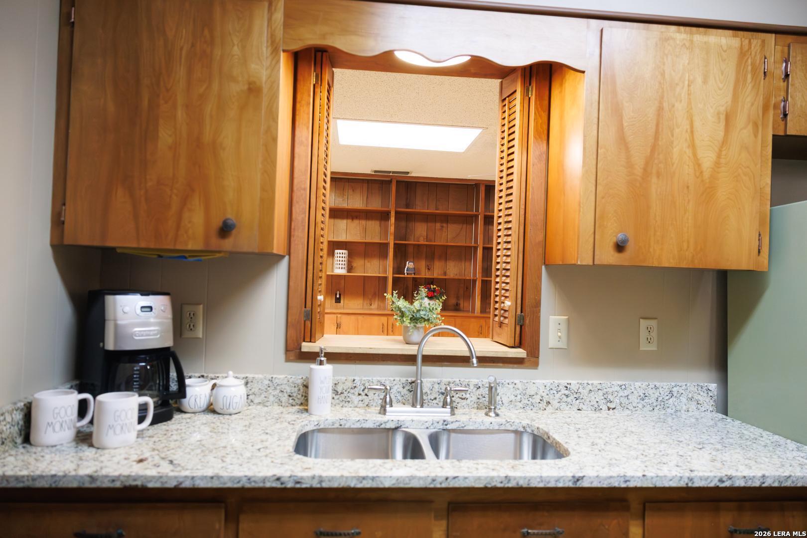 105 South Sayers Drive Devine, TX 78016 - Photo 6 of 23 a bathroom with a granite countertop sink and a mirror